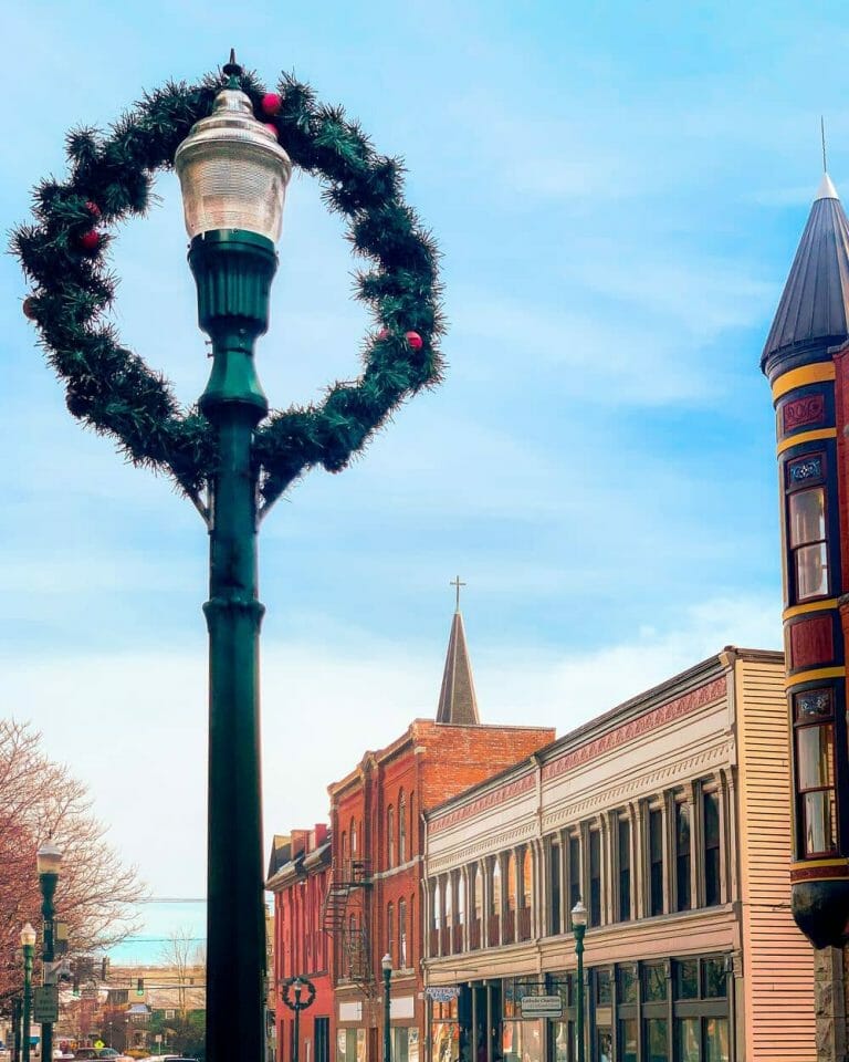 A street light adorned with a festive wreath.