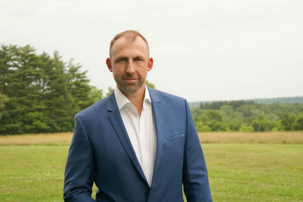 A man in a blue suit delivering a message.